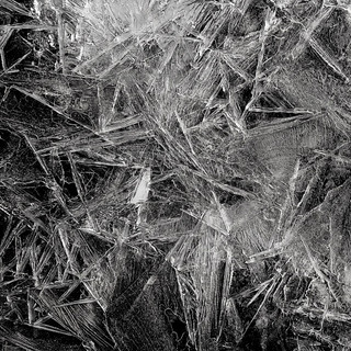 Jagged black-and-white ice crystals on a dark background — scent inspiration for Black Ice fragrance oil
