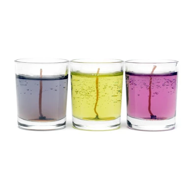 Three glass container candles filled with colored gel wax, displayed side by side. The candles feature purple, yellow, and pink gel wax with visible bubbles and centered wicks. The setup is on a white background, highlighting the transparency and vibrant colors of the gel wax.
