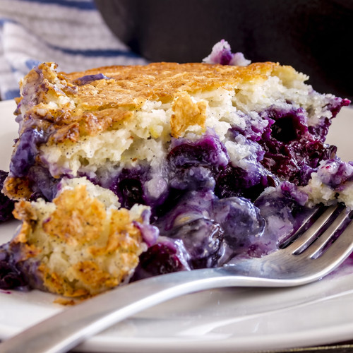 Slice of blueberry cobbler with a fork on a white plate — scent inspiration for Blueberry Cobbler fragrance oil