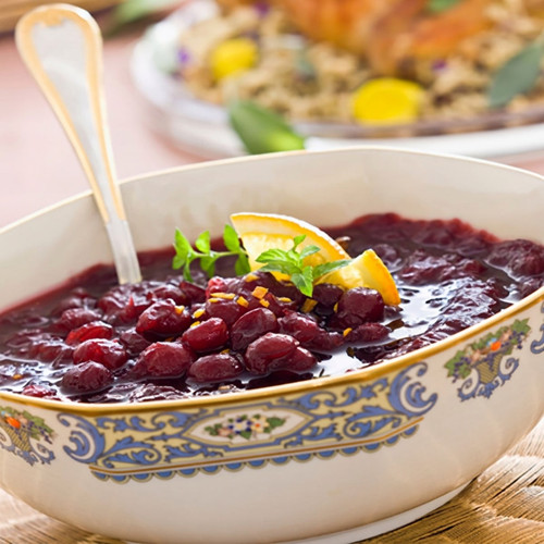 Dark cranberry sauce in an ornate bowl with orange slice — scent inspiration for Cranberry Chutney fragrance oil