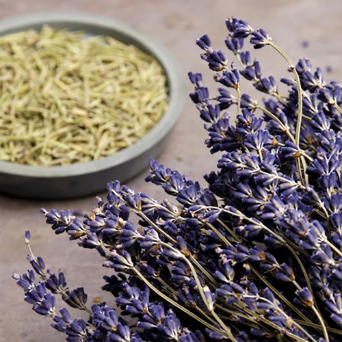 Purple lavender bunch beside a bowl of dried herbs — scent inspiration for Lavender fragrance oil