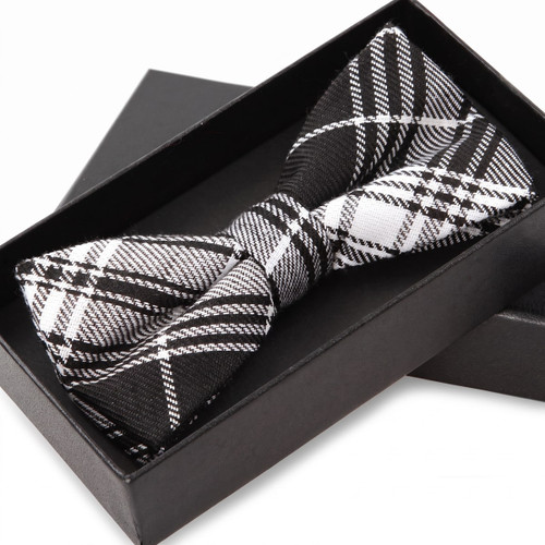 Black and white plaid bow tie in a gift box — scent inspiration for Burberry Brit fragrance oil