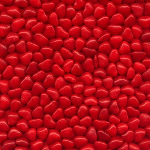Pile of small red heart-shaped cinnamon candies — scent inspiration for Red Hot Cinnamon fragrance oil
