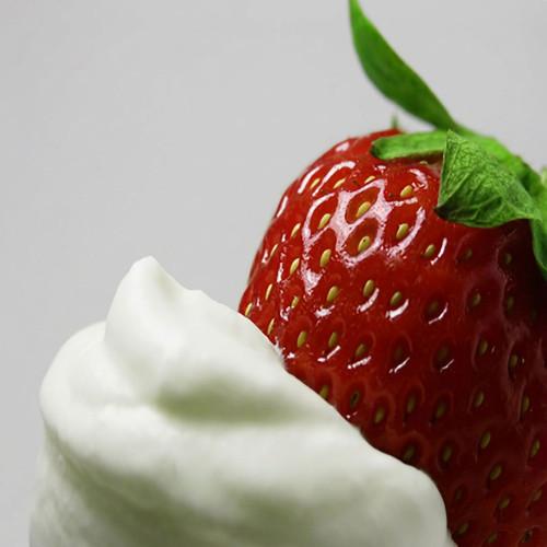Red strawberry beside a swirl of white cream — scent inspiration for Strawberries & Cream fragrance oil
