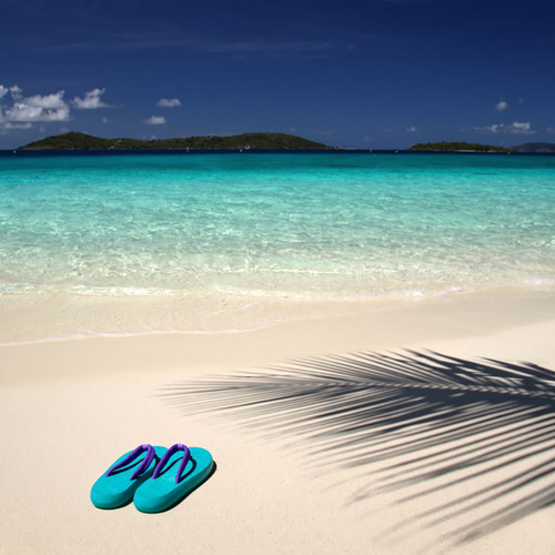 Teal flip-flops on white sand by turquoise sea — scent inspiration for Butt Naked fragrance oil