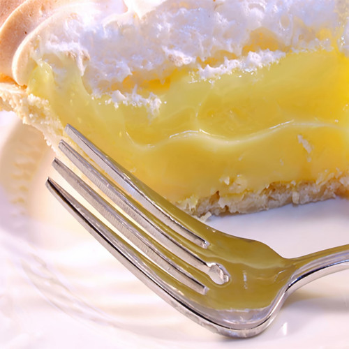 Slice of lemon meringue pie with fork on white plate — scent inspiration for Lemon Chiffon fragrance oil