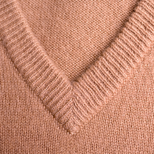 Close-up of a tan V-neck knit sweater — scent inspiration for Cashmere fragrance oil