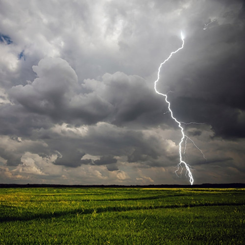 Lightning striking over a green field, dark storm clouds — scent inspiration for Storm Watch fragrance oil