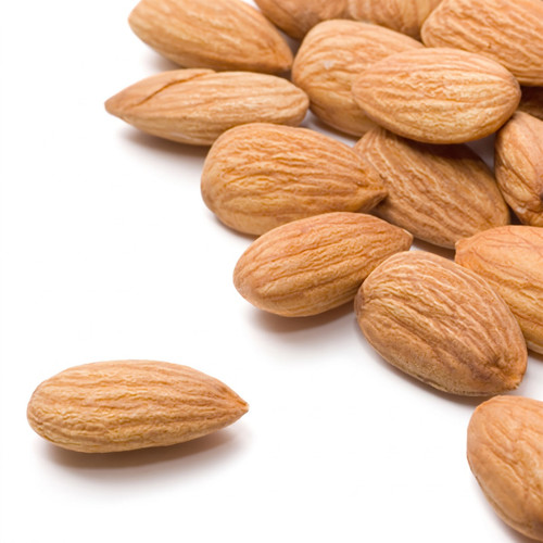 Pile of whole almonds on white background — scent inspiration for Almond fragrance oil