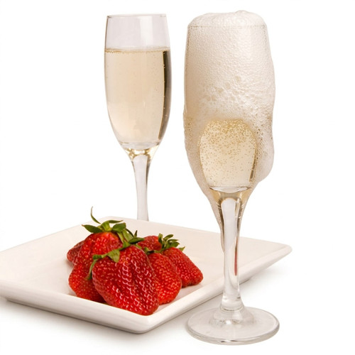 Champagne flutes and red strawberries on a white plate — scent inspiration for Strawberries & Champagne fragrance oil