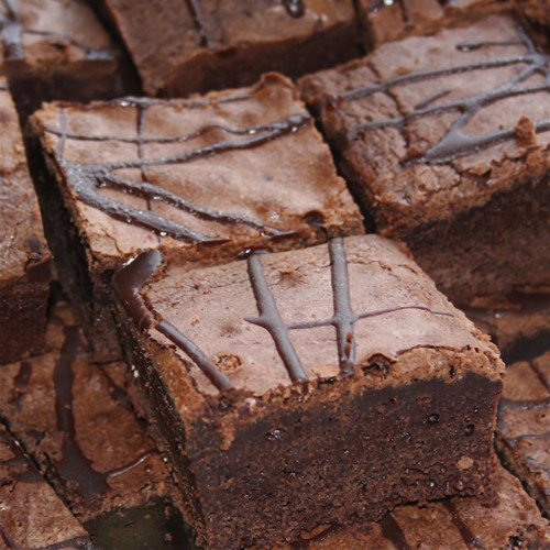 Stacked chocolate brownies drizzled with dark chocolate — scent inspiration for Fudge Brownie fragrance oil