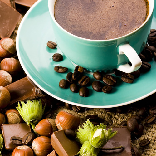 Teal cup of coffee with beans, hazelnuts and chocolate — scent inspiration for Hazelnut Coffee fragrance oil