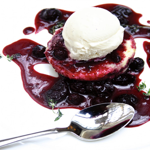 Vanilla ice cream scoop on cake with dark berry sauce, spoon — scent inspiration for Black Raspberry Vanilla fragrance oil