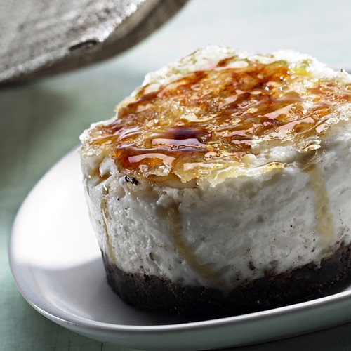 Caramel-topped cheesecake slice on a white plate — scent inspiration for Creme Brulee fragrance oil