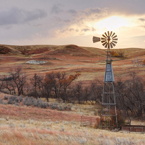 Metal windmill over rolling prairie at sunset — scent inspiration for Open Range fragrance oil