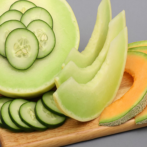 Sliced cucumber, honeydew, and cantaloupe on a board — scent inspiration for Cucumber Melon fragrance oil