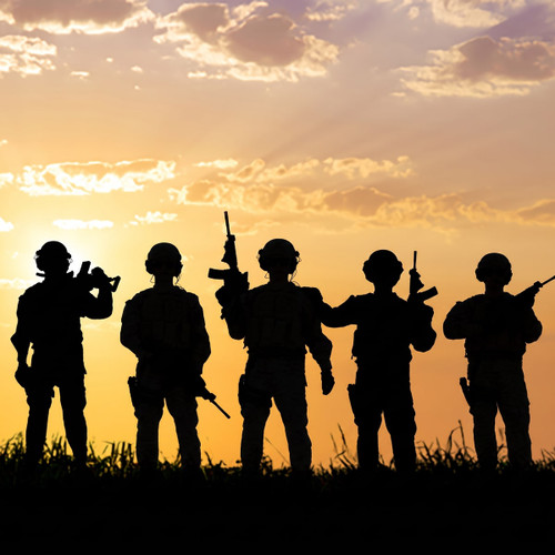 Silhouetted armed soldiers against an orange sunset sky — scent inspiration for Dauntless fragrance oil