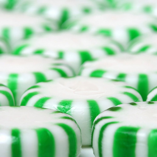 Green and white striped round mint candies — scent inspiration for Spearmint fragrance oil