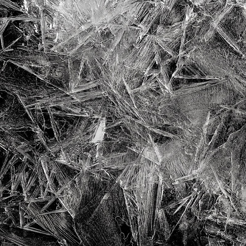 Jagged black-and-white ice crystals on a dark background — scent inspiration for Black Ice fragrance oil