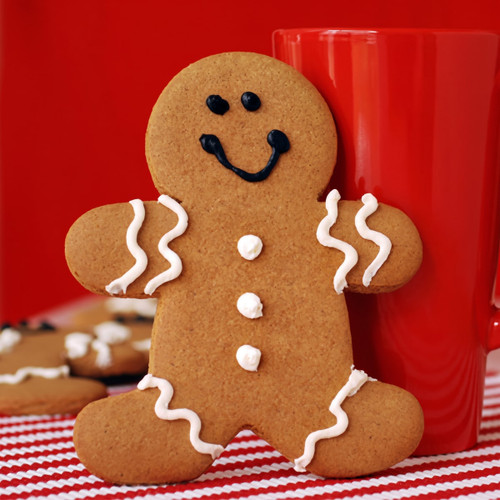 Gingerbread man cookie beside a red mug — scent inspiration for Gingerbread fragrance oil