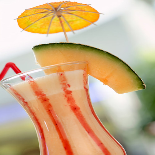 Creamy drink with a melon slice and orange umbrella — scent inspiration for Exotic fragrance oil