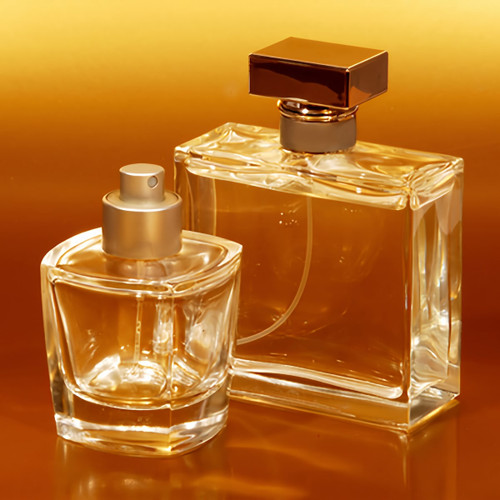 Two glass perfume bottles against glowing amber background — scent inspiration for Amber Vanilla fragrance oil