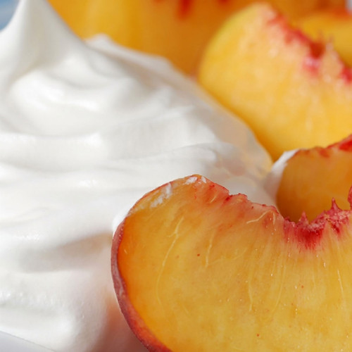 Peach slices with white whipped cream — scent inspiration for Peaches & Cream fragrance oil