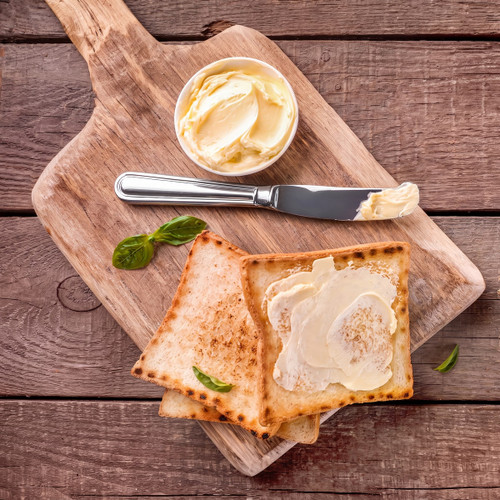 buttered toast, butter dish and knife on wooden board — scent inspiration for Honey Maple Butter fragrance oil