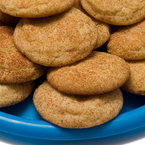 Cinnamon-sugar cookies piled on a blue plate — scent inspiration for Snickerdoodle fragrance oil