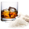 Glass of iced amber drink beside shredded coconut — scent inspiration for Coconut Bourbon fragrance oil