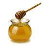 Glass jar of honey with a wooden dipper on white — scent inspiration for Honey fragrance oil
