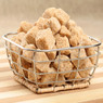 Brown sugar cubes in a wire basket on wood — scent inspiration for Brown Sugar fragrance oil