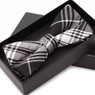 Black and white plaid bow tie in a gift box — scent inspiration for Burberry Brit fragrance oil