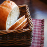 Loaf of sliced white bread in a wicker basket — scent inspiration for Fresh Baked Bread fragrance oil