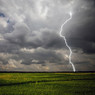 Lightning striking over a green field, dark storm clouds — scent inspiration for Storm Watch fragrance oil