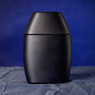 Matte black rounded jar on dark blue cloth — scent inspiration for Drakkar Noir fragrance oil