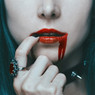 Woman's red lips with dripping red, hand and rings — scent inspiration for Vampire Blood fragrance oil