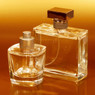 Two glass perfume bottles against glowing amber background — scent inspiration for Amber Vanilla fragrance oil