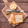 buttered toast, butter dish and knife on wooden board — scent inspiration for Honey Maple Butter fragrance oil