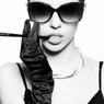 Black-and-white portrait of a woman in sunglasses, gloves, and pearls — scent inspiration for Diva fragrance oil