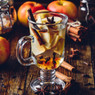 Spiced apple tea with cinnamon and star anise on dark wood — scent inspiration for Apple Chai fragrance oil