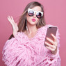 woman in pink fur coat and sunglasses taking a selfie — scent inspiration for High Maintenance fragrance oil