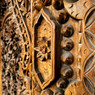 close-up of ornately carved brown wood panel — scent inspiration for Island Teakwood fragrance oil