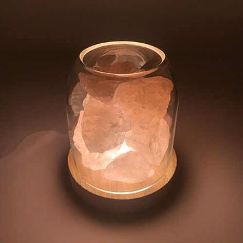 AURORA DIFFUSER ROSE QUARTZ
Ambient crystal diffuser with light. When crystals meet essential oils, a harmonising combination of healing energy is created and released into its immediate surroundings.

AURORA is a spirited and versatile diffuser. It springs to life once the light is turned on, emitting a pretty pink glow.

A diffuser that delivers divine vibrations into any room it is placed. It’s natural wooden base and glass reservoir is filled with a blissful union of rose quartz stones which are then sprinkled with your choice of essential oils.

ROSE QUARTZ is known for its amazing soothing properties, boosts feelings of peace and tranquility. A wonderful stone to heal and protect the heart, balance emotions, relieve stress and tension. Known as the ‘love stone’ rose quartz allows love and calmness to flow within.