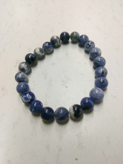 Power Bracelet Sodalite
Sodalite offers a gentle soothing quality which can increase insight, intuition and mental abilities. It is useful as a stone for creative expression, assisting in finding one’s creative voice. Wisdom, logic, calmness, healing, stress reduction, companionship, self-esteem, work in groups, heal communication breeches, truth, intelligence, knowledge, learning. Use for glands, digestive system, insomnia, calcium deficiency, head colds.