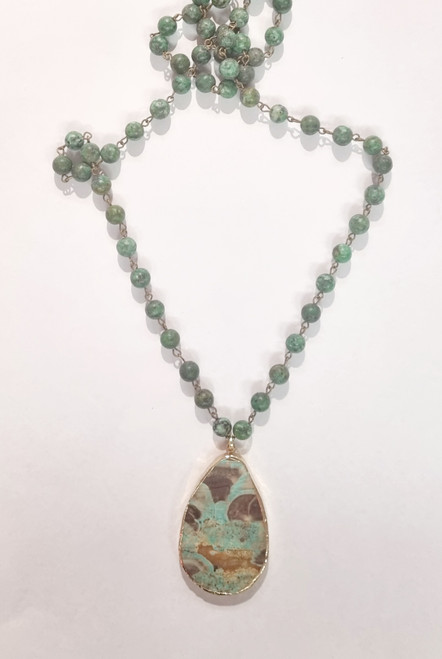 Gemstone Necklace Chrysocolla
8cm round Chrysocolla beads
88cm long
Chrysocolla pendant is approx 5.75x 3.75 cm

Chrysocolla - Teaches unconditional love. A nurturing heart chakra stone. It is used as a stone for Earth healings. It can link us to the Earth’s energies. In some traditions this stone represents Mother Earth. It reminds us to treasure the Earth, physically and spiritually. Chrysocolla brings about harmony, stamina, wisdom, peace, love, communication, vitality, inner strength, purifies a place, removes negativity, reduces fear, anxiety and guilt. Easing heartache. Good for asthma, TB, pneumonia, muscle cramps, arthritis, pregnancy & childbirth.