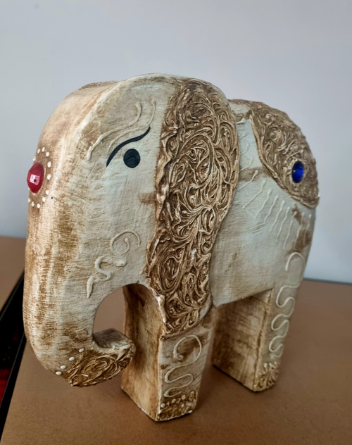 Elephant Jeweled
Standing in protection mode
Handcrafted from wood
Decorated with jewels & carved body work
Approx 20cm L x 19cm H x 5cm W