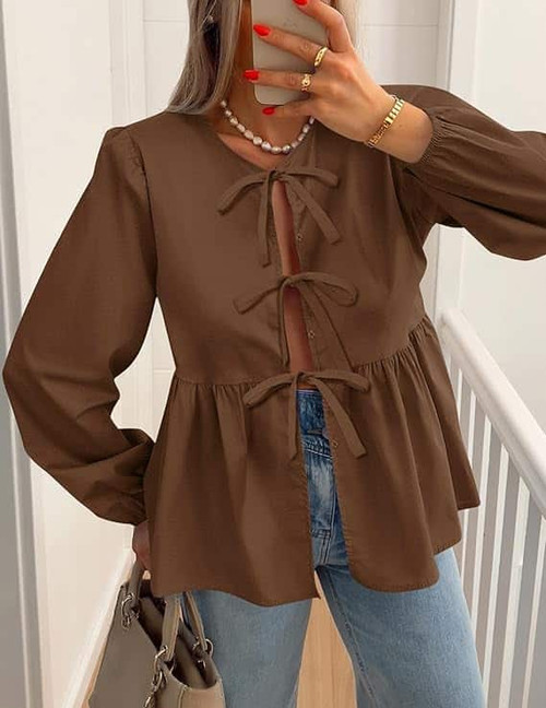 Mutig Tie Top Brown

Bow-Tie Front Long Sleeves Shirt

Soft, lightweight fabric 
Statement tie-front closure 
Peplum-style waist 
Long sleeves with elastic cuffs

Fabric: 100% Cotton