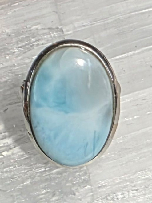 Ring Larimar Oval Size 9
Set in Sterling Silver
Size Approx 2.5 x 1.5 cm

Larimar- is sometimes called the stone of the Caribbean because of where it is found & also for its blue color. It is a most soothing and serene stone, able to calm and relax the emotions. It can bring peace and calm to any situation. It supports a state of wellbeing and reminds us that all is well. It is useful for the throat chakra, providing the power of clear communication. Also known as a Goddess Stone. It is useful for hot flashes, as it can bring a cooling, calm feeling. Also Throat, upper respiratory system, schizophrenia