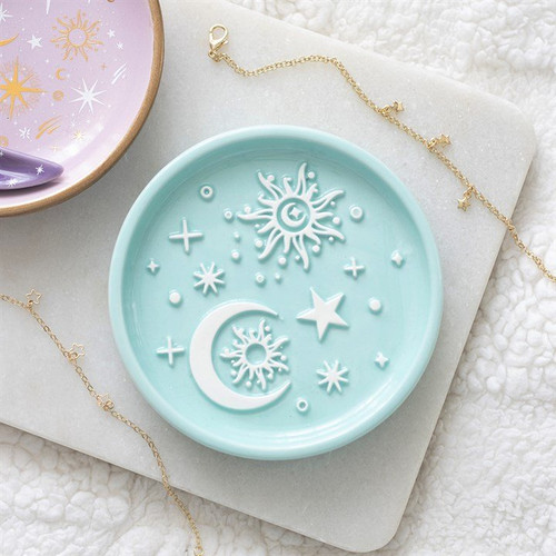 Dish Pastel Moon & Sun
Enhance your jewellery storage with a touch of celestial charm using this Blue Moon and Sun Trinket Dish. Adorned with a pastel blue finish and a raised white moon, sun, and star motif, this elegant dish adds a serene and stylish element to dressing tables, bedside tables, and vanity areas. Ideal for storing rings, earrings, bracelets, and other small treasures, it seamlessly blends practical functionality with celestial aesthetics. A thoughtful gift for birthdays, housewarmings, or anyone who appreciates moon and sun designs, pastel decor, and mystical home accessories, this trinket dish is part of the Pastel Skies collection of celestial gifts and home decor.

Product Size: H 1.9 cm x W 10.9 cm x D 10.9 cm